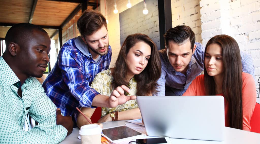 photo of young temporary office workers sitting together