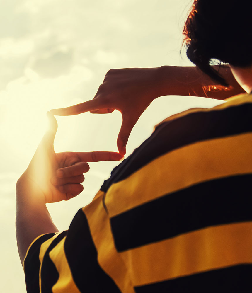 photo of person holding their fingers in a way to make it look like their looking through a camera lens