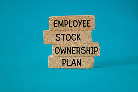 Employee Stock Ownership Plan words spelled out on wooden blocks.